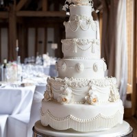 white six tier cake with sugar icing details