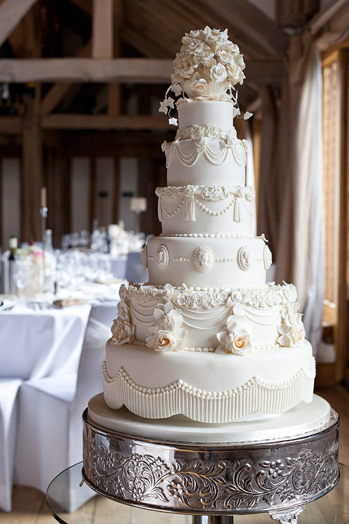 white six tier cake with sugar icing details